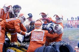 Marshals help Rene'Arnoux (FRA) Renault Re 30B Turbo from his crashed car at Tarzan corner