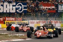 Rene'Arnoux (FRA) Ferrari 126 C3 2nd position leads a group at prima variante.Andrea de Cesaris (ITA) 183T spin