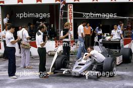 Frank Williams and engineers at work with FW 08C Ford Cosworth car