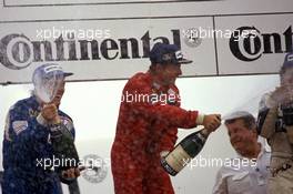 Rene'Arnoux (FRA) Ferrari 1st position Andrea de Cesaris (ITA) Alfa Romeo 2nd position celebrates on podium