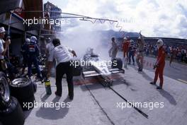 Keke Rosberg (FIN) Williams FW 08C Ford Cosworth problems of fire during pit stop