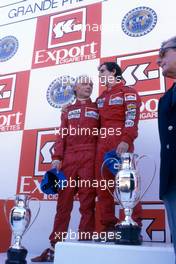 Niki Lauda (AUT) McLaren 2nd position and World Trichampion Alain Prost (FRA) McLaren 1st position celebrates podium