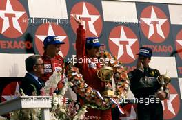 Alain Prost (FRA) McLaren 1st position Niki Lauda (AUT) McLaren 2nd position Nigel Mansell (GBR) Lotus 3rd position and Jean Marie Balestre Fia and FFSA president celebrates podium