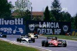 Michele Alboreto (ITA) Ferrari 156/85 leads a group at Variante Alta