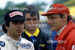 Niki Lauda (AUT) McLaren talks with Nelson Piquet (BRA) Brabham in the background Gastone Giarolo (ITA) Fiamm