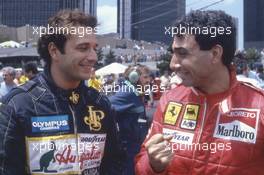 Elio de Angelis (ITA) Lotus talks with Michele Alboreto (ITA) Ferrari