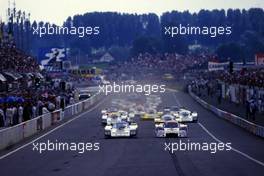 Derek Bell (GBR) Hans Joachim Stuck (GER) Porsche 962C GrC1 Porsche Rothmans 3rd position battles with Bob Wollek (FRA) Mauro Baldi (ITA) Lancia Lc2 GrC1 Martini Racing at start
