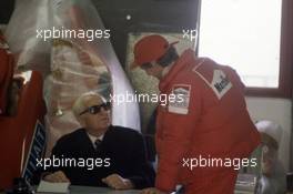 Enzo Ferrari (ITA) talks with Niki Lauda (AUT) McLaren