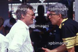 Bernie Ecclestone (GBR) Brabham talks with Peter Warr (GBR) Lotus