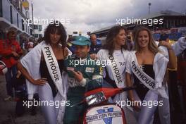 Teo Fabi (ITA) Toleman celebrate pole position with gridgirls on the motor bike Vespa Piaggio