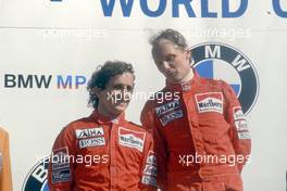 Alain Prost (FRA) McLaren 2nd position and teammate Niki Lauda (AUT) 1st position celebrates podium