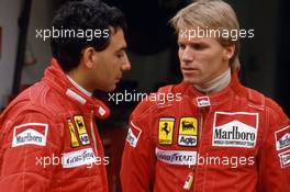 Michele Alboreto (ITA) Ferrari talks with teammate Stefan Johansson (SWE)