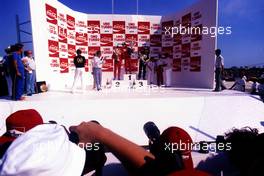 Michele Alboreto (ITA) Ferrari 2nd position Alain Prost (FRA) McLaren 1st position Elio de Angelis (ITA) Lotus 3rd position celebrates podium