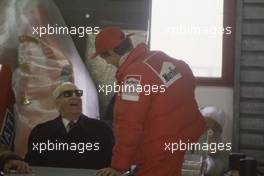 Enzo Ferrari (ITA) talks with Niki Lauda (AUT) McLaren