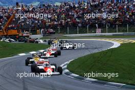Alain Prost (FRA) McLaren MP4/2B Tag Porsche 1st position leads a group at start