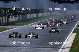Ayrton Senna da Silva (BRA) Lotus 98T Renault 3rd position battles with Nelson Piquet (BRA) Williams FW11 Honda at start