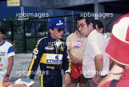 Ayrton Senna da Silva (BRA) Lotus talks with the father Milton da Silva (BRA)