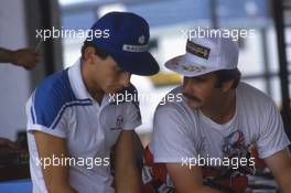 Ayrton Senna (BRA) Lotus talks with Nigel Mansell (GBR) Williams