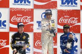 Ayrton Senna (BRA) Lotus 2nd position Nelson Piquet (BRA) Williams 1st position Jacques Laffite (FRA) Ligier 3rd position celebrates on podium