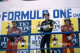 Nigel Mansell (GBR) Williams 2nd position Ayrton Senna da Silva (BRA) Lotus 1st position Alain Prost (FRA) McLaren 3rd position celebrates podium