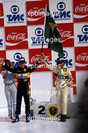 Ayrton Senna da Silva (BRA) Lotus 98T Renault 2nd position and Nelson Piquet (BRA) Williams Honda 1st position celebrates podium
