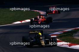 Ayrton Senna da Silva (BRA) Lotus 98T Renault leads Michele Alboreto (ITA) Ferrari F186 at variante Acque Minerali