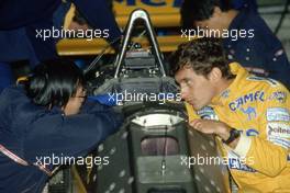 Ayrton Senna da Silva (BRA) Lotus 99T Honda talks with a Honda engineer