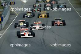 Alain Prost (FRA) McLaren MP4/4 Honda 1st position leads the group at start