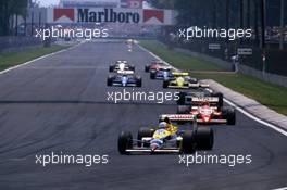 Nigel Mansell (GBR) Williams FW12 Judd leads a group