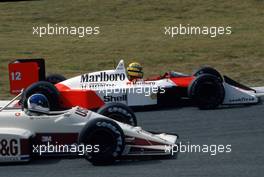 Ayrton Senna da Silva (BRA) McLaren MP4/4 Honda 1st position passes Derek Warwick (GBR) Arrows A10B Megatron