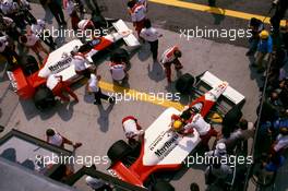 Ayrton Senna da Silva (BRA) McLaren MP4/4 Honda 1st position and teammate Alain Prost (FRA) 3rd position iduring pit stop