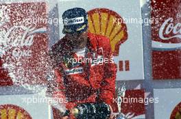 Nigel Mansell (GBR) Ferrari 640 1st position celebrates podium