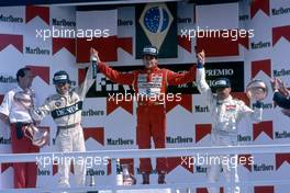 Riccardo Patrese (ITA) Williams 2nd position Ayrton Senna da Silva (BRA) McLaren 1st position Michele Alboreto (ITA) Tyrrell 3rd position celebrates podium