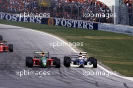 Nelson Piquet (BRA) Benetton B190 Ford Cosworth battles with Jean Alesi (FRA) Tyrrell 019 Ford Cosworth