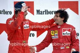 Nigel Mansell (GBR) 2nd position Alain Prost (FRA) Ferrari 1st position celebrates podium