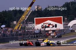 Riccardo Patrese (ITA) Williams FW13B Renault 1st position leads Alain Prost (FRA) Ferrari 641