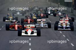 Ayrton Senna da Silva (BRA) McLaren MP4/6 Honda 1st position leads the group at start