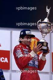 Ayrton Senna da Silva (BRA) McLaren Honda 1st position celebrates podium