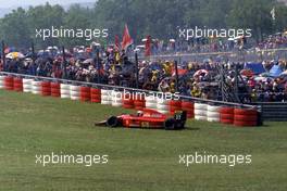 Alain Prost (FRA) Ferrari 642 on the grass during formation lap of grand prix and withdraw