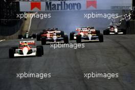 Ayrton Senna da Silva (BRA) McLaren MP4/6 Honda 1st position leads a group at start