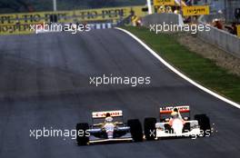 Nigel Mansell (GBR) Williams FW14 Renault 1st position battles with Ayrton Senna da Silva (BRA) McLaren MP4/6 Honda