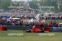 Alain Prost (FRA) Ferrari 642 on the grass during formation lap of grand prix and withdraw