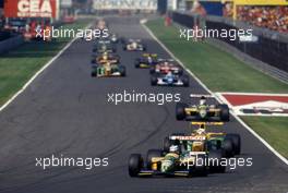 Mika Hakkinen (FIN) Lotus 107 Ford Cosworth leads a group