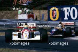 Ayrton Senna da Silva (BRA) McLaren MP4/7A Honda 1st position leads Nigel Mansell (GBR) Williams FW14B Renault 2nd position
