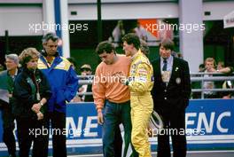 Ayrton Senna da Silva (BRA) McLaren Mp4/7A Honda talks with Michael Schumacher (GER) Benetton B 192 Ford after crash at Adelaide corner on first lap