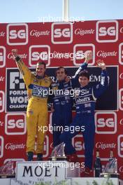 Alain Prost (FRA) Williams celebrates on podium 2nd position in the race and victory of the Drivers World Championship for the fourth time Michael Schumacher (GER) Benetton 1st position Damon Hill (GBR) Williams 3rd position