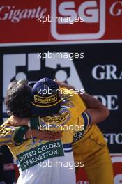 Michael Schumacher (GER) Benetton 1st position celebrates on podium victory with Flavio Briatore (ITA)