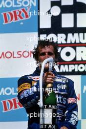 Alain Prost (FRA) Williams 1st position celebrates on podium with champagne
