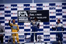 Michael Schumacher (GER) Benetton 2nd position Alain Prost (FRA) Williams 1st position Mark Blundell (GBR) Ligier 3rd position celebrates on podium
