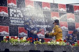 Damon Hill (GBR) Williams 1st position Michael Schumacher (GER) Benetton 2nd position Alain Prost (FRA) Williams 3rd position celebrates on podium with champagne